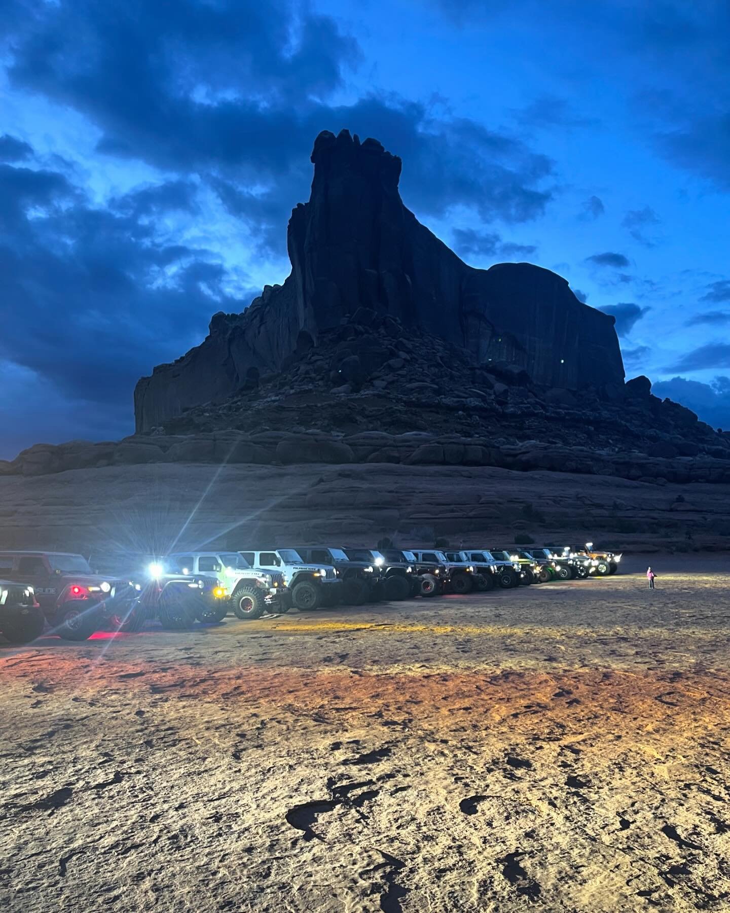 SEMA Joins Treadlightly! for Off-Roading Stewardship at Easter Jeep Safari - Line of Jeeps in the desert just after sunset.