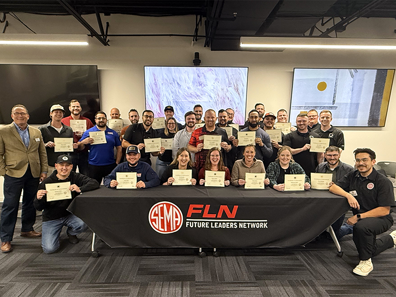 FLN PDP participants posing around a table with the FLN logo displayed