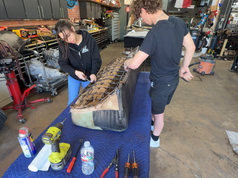 Two students working a part in Shop Class