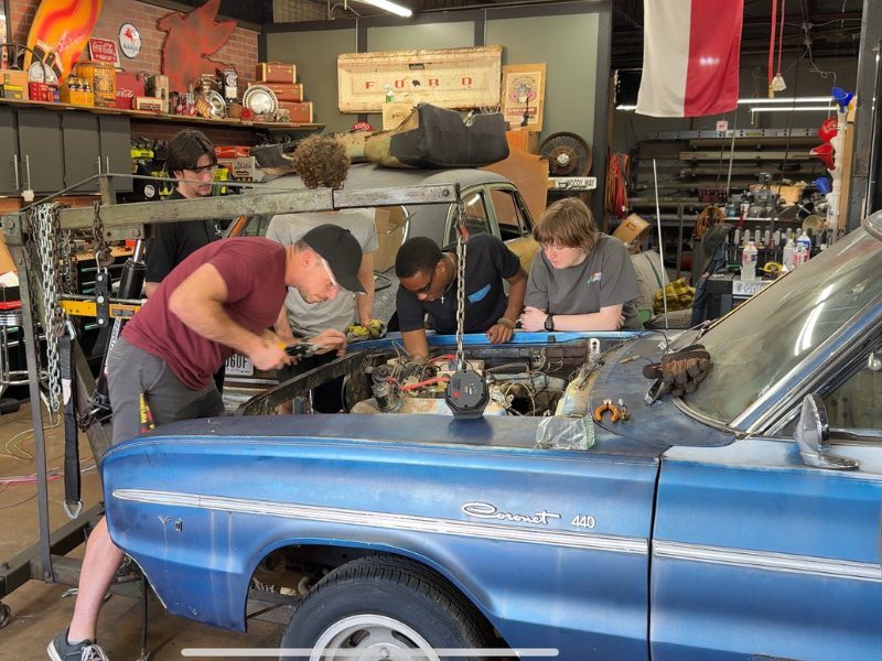 Students working on a Mercury Comet in Shop Class.