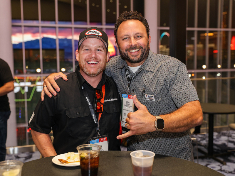Couple of guys smiling for the camera at the WTSBC Reception