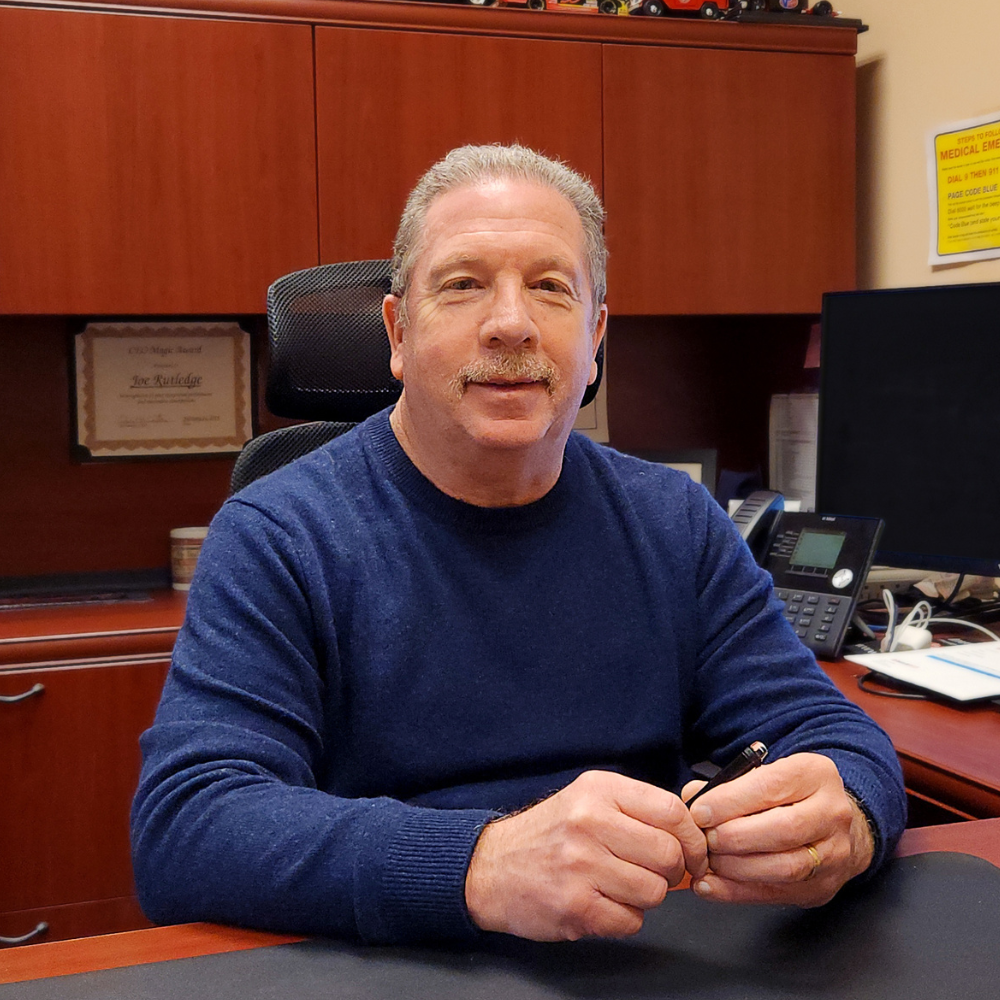 Joe Rutledge sitting at a desk