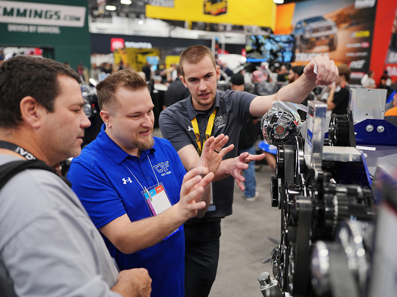An image of exhibitors talking to buyers at the SEMA Show.