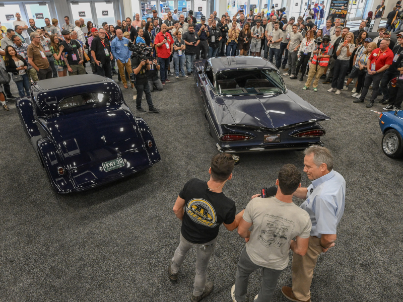Crowd gathered around some booth vehicles