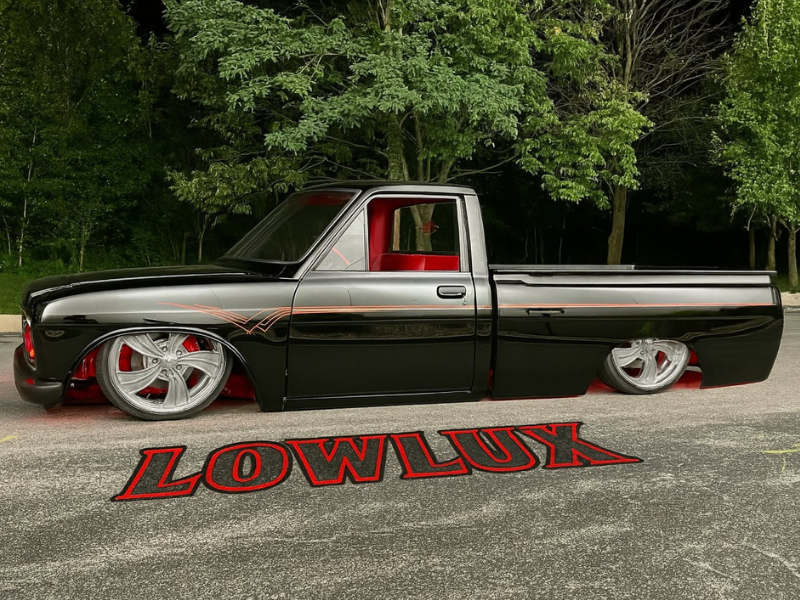 Lowered truck with Lowlux overlaid on road next to truck