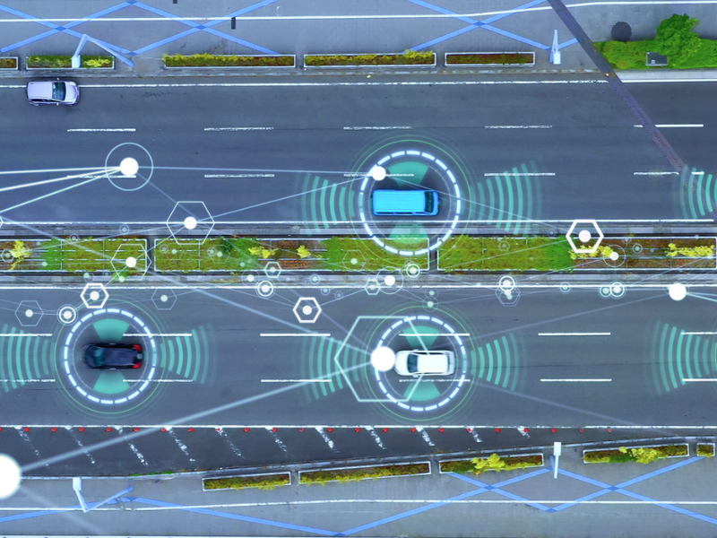 Top down view of a illustrated street scene with cars using radar or ADAS systems