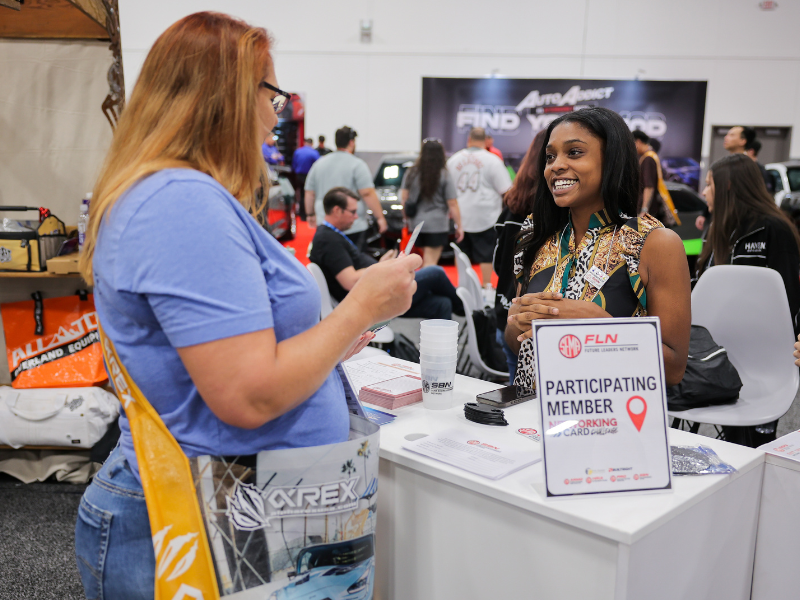 Two women talking to each other at the SBN Booth
