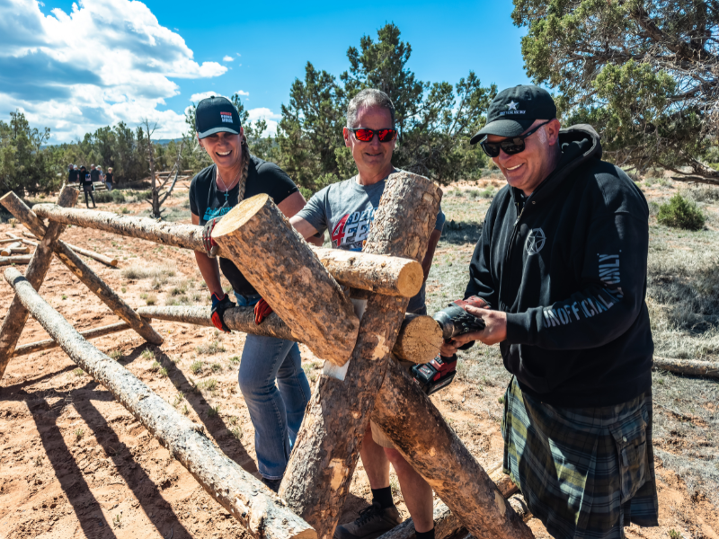 Volunteers repairing fencing along trail