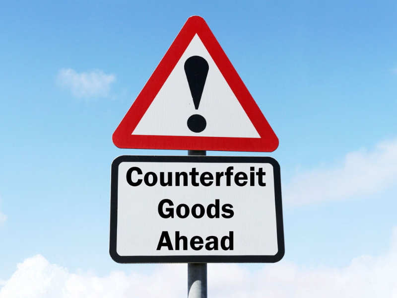 Road sign with "Counterfeit Goods Ahead".