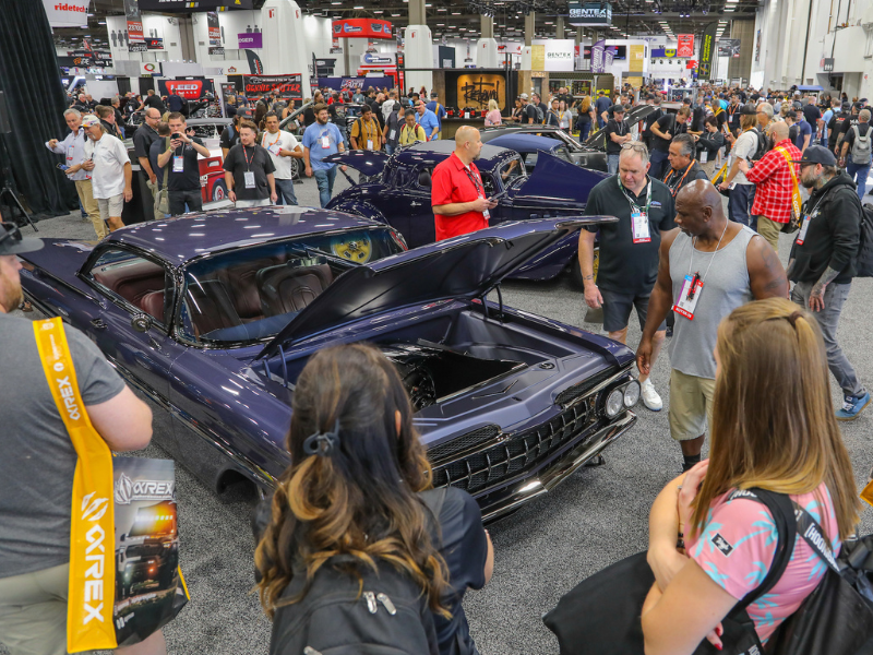 Crowd gathered around a featured vehicle at the SEMA Show. 
