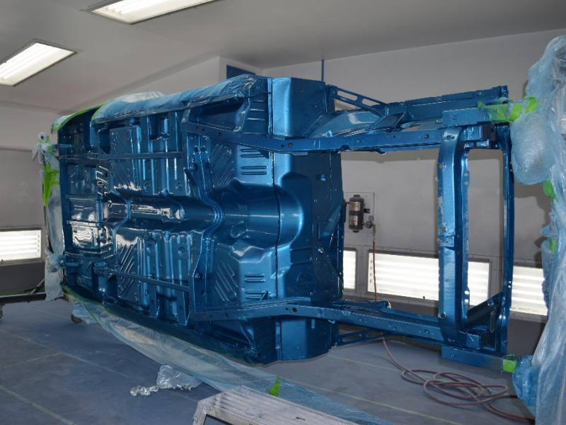 Chassis turned on its side in a paint booth