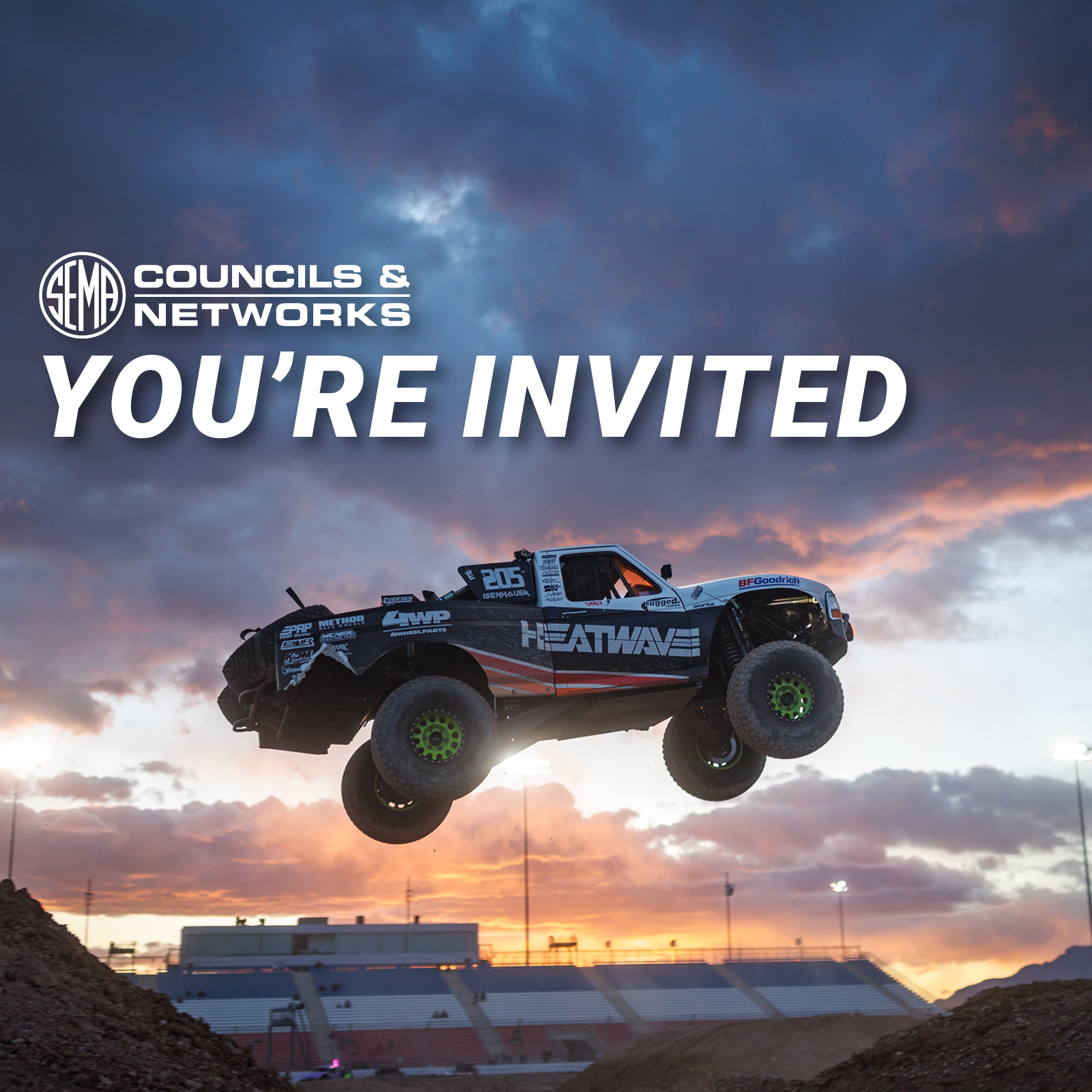 TORA - You're invited. Off-road truck flying through the air.