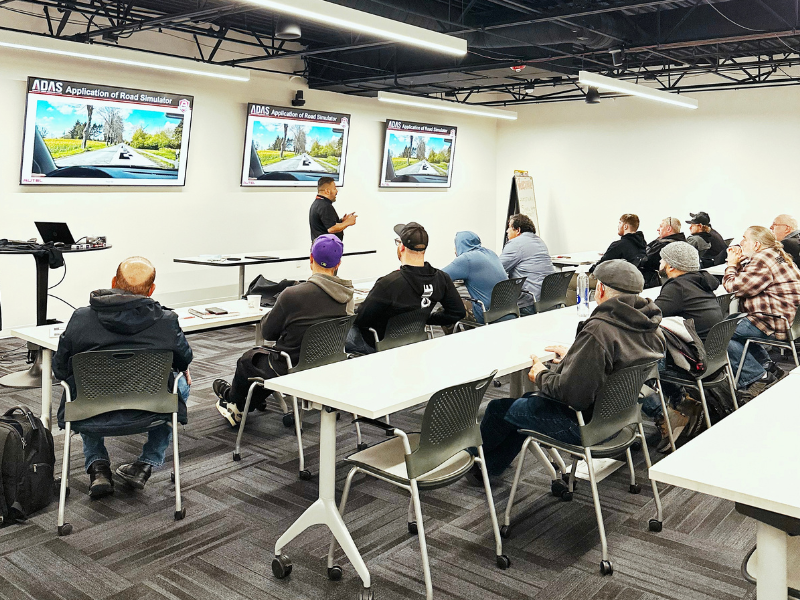 People sitting in a classroom setting listening to an Instructor