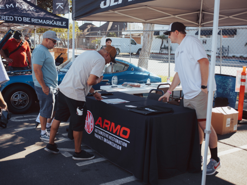 People perusing the ARMO outdoor booth.
