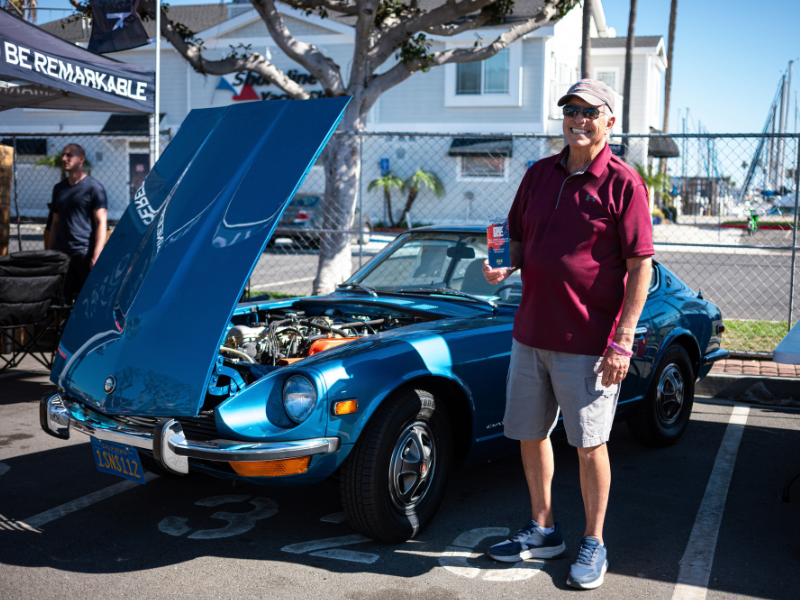Man standing next to Datsun 240