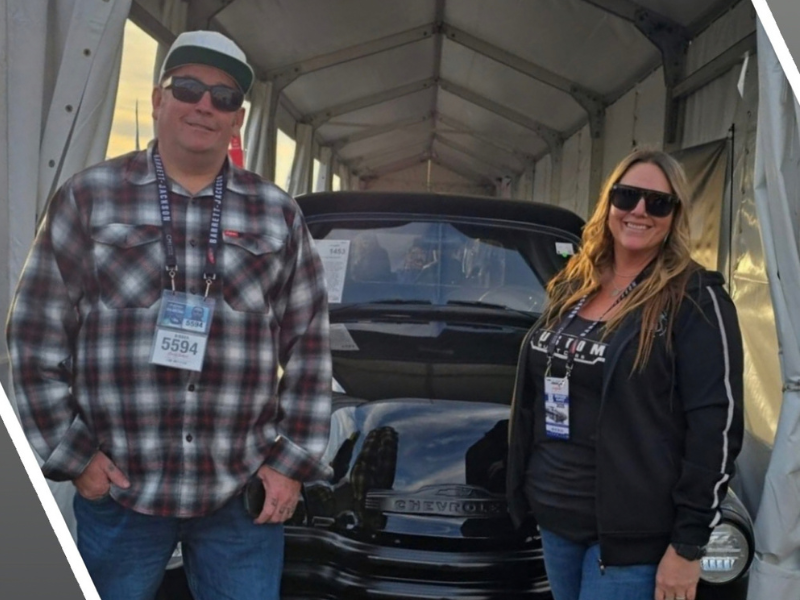 Couple posing with a Chevrolet build