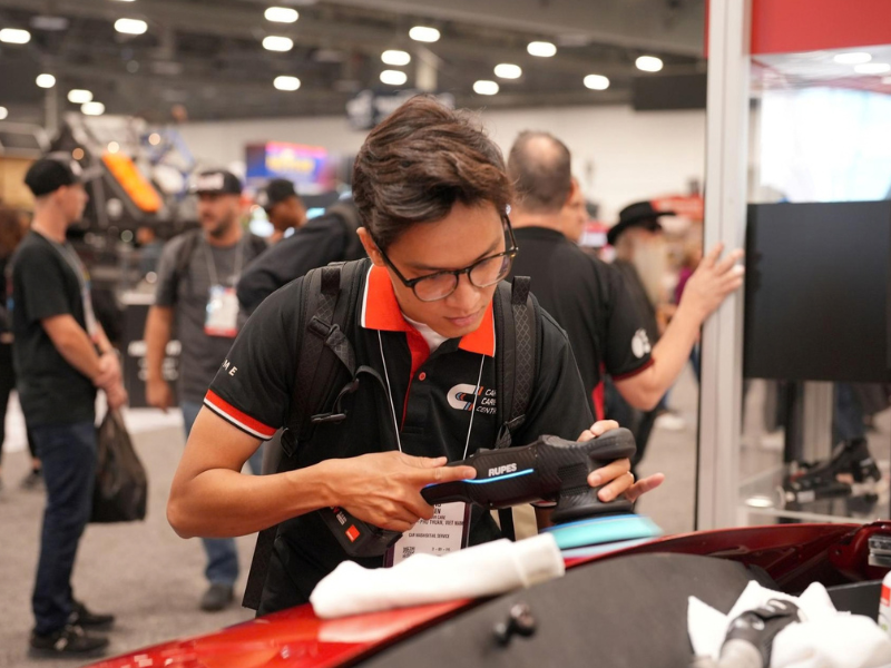 Buyer trying product at a booth at the SEMA Show