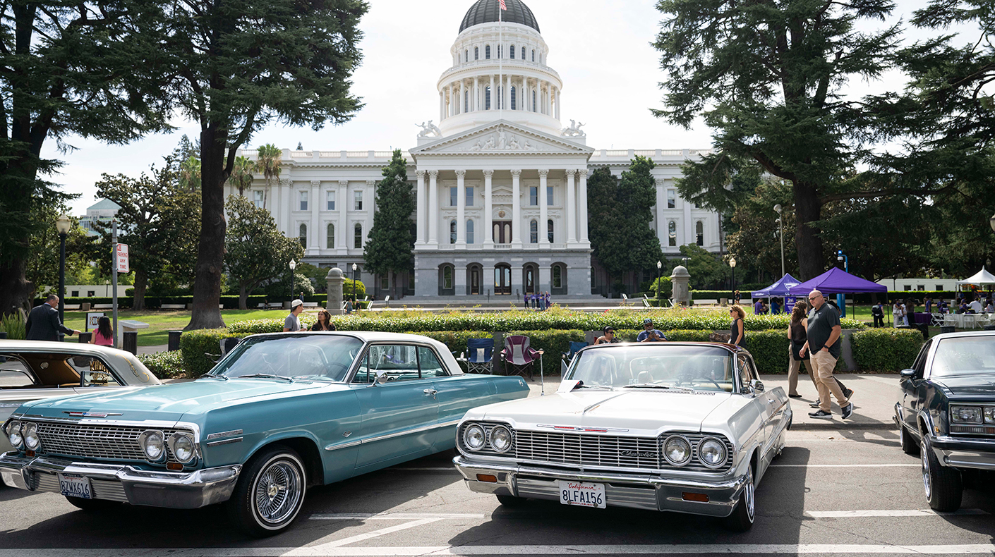 Classic cars parked outside the California state house.