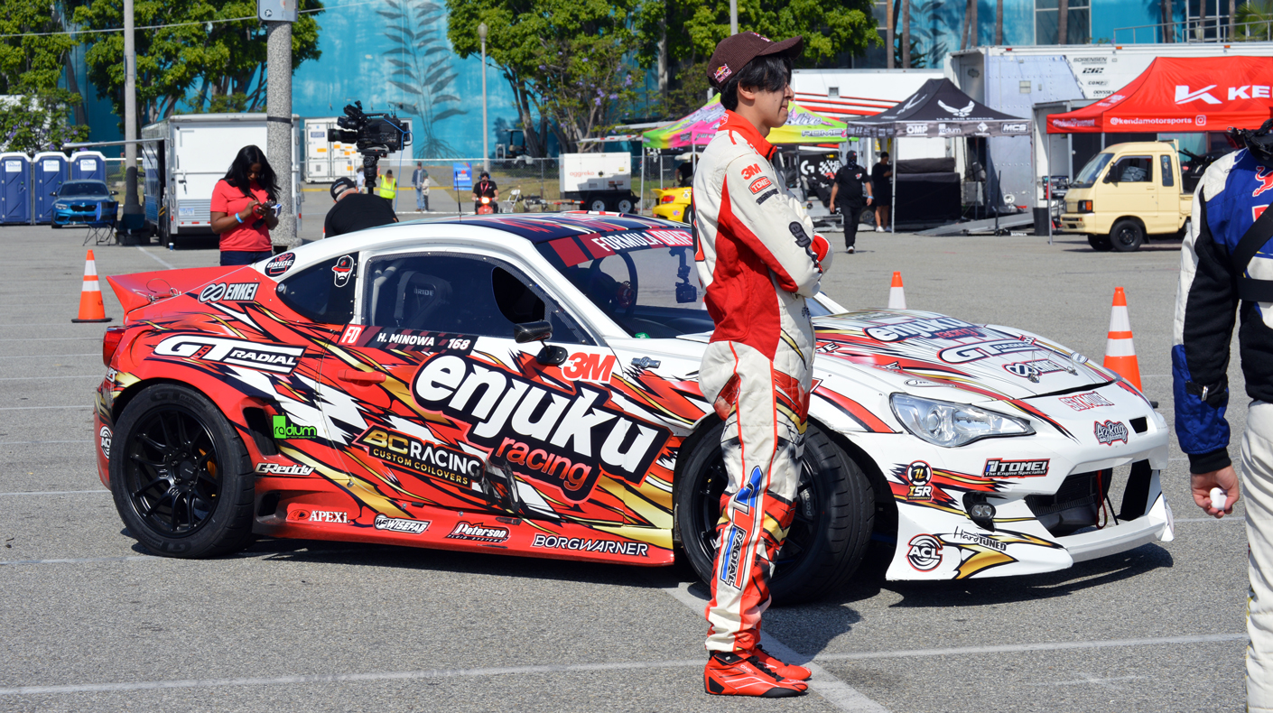 An image of Hiroya Minowa next to his drift vehicle.