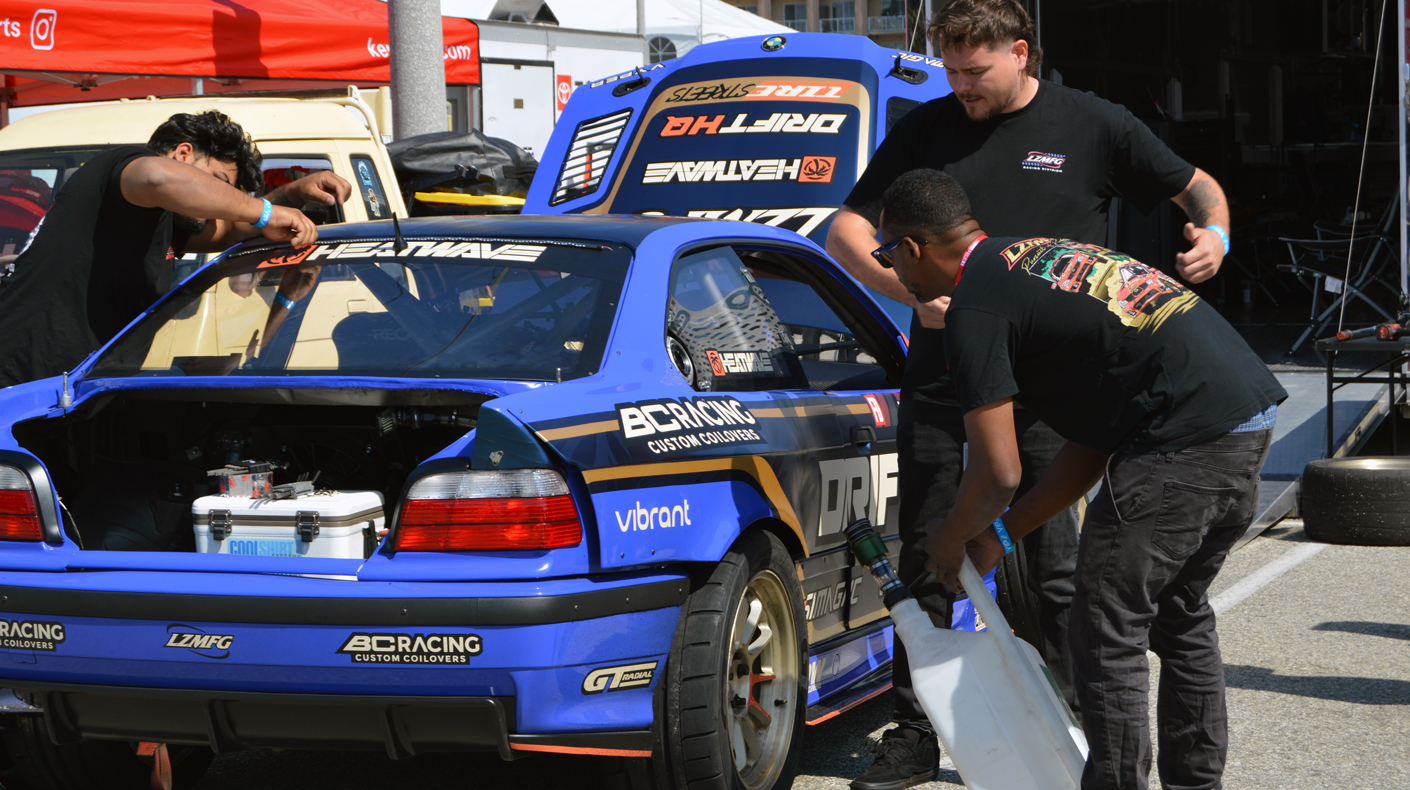 A Formula Drift team working on the vehicle.