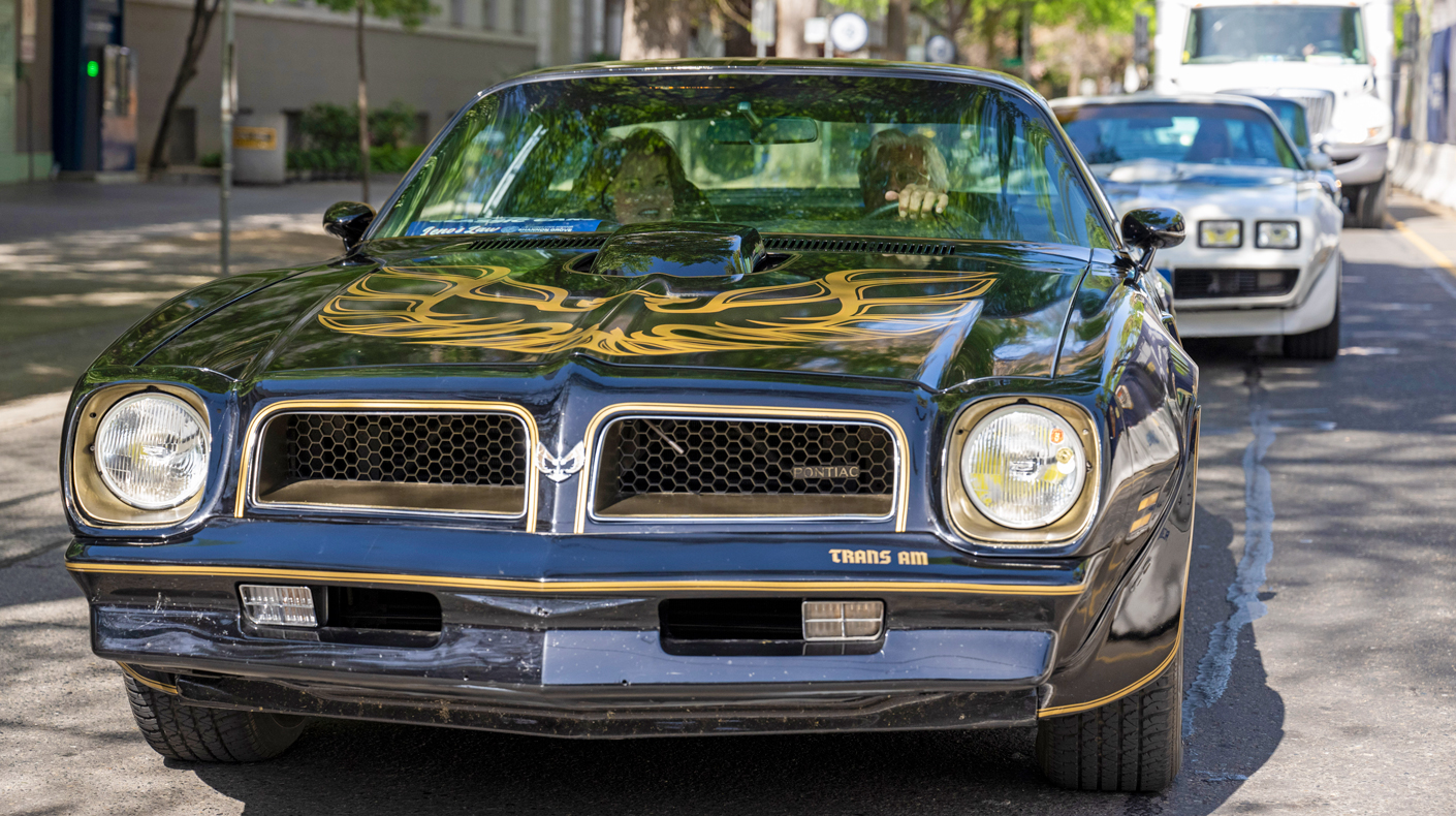 Senator Shannon Grove sits passenger in a classic Trans Am driven by Jay Leno.