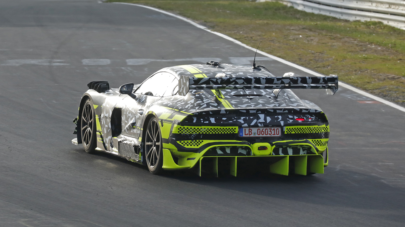 An image of a camouflaged Mercedes AMG Coupe on the race track.