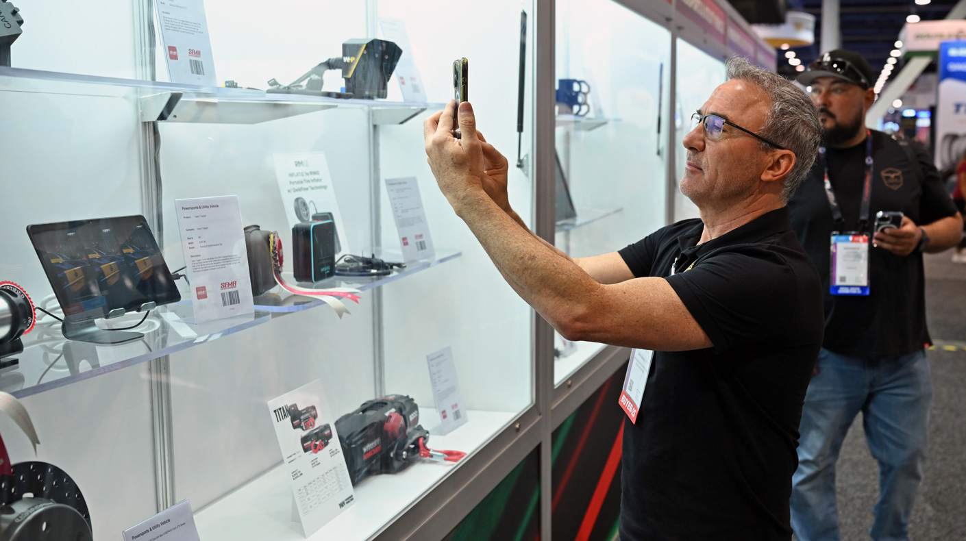 2025 SEMA Show New Products Showcase - A visitor captures product highlights to share with colleagues and customers back home.
