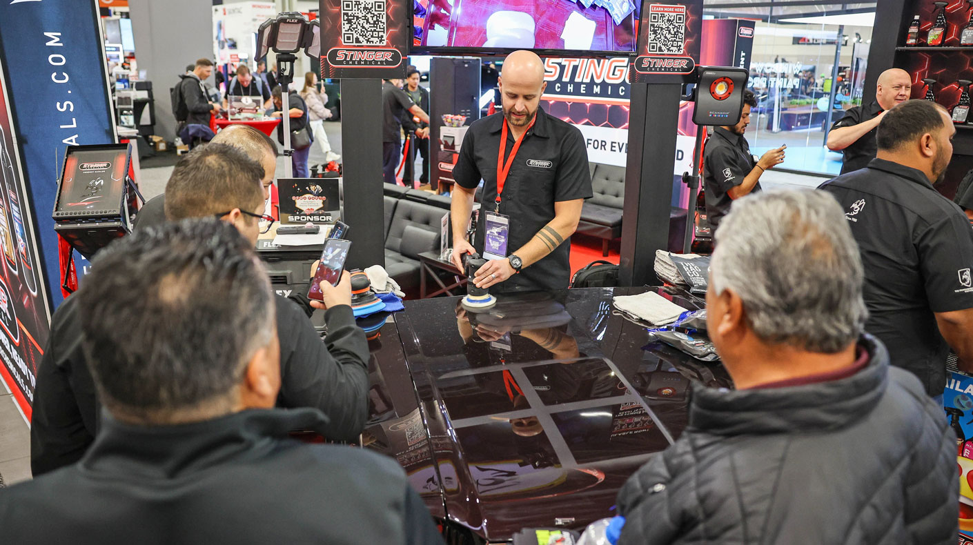 SEMA Show exhibitor talking to customers