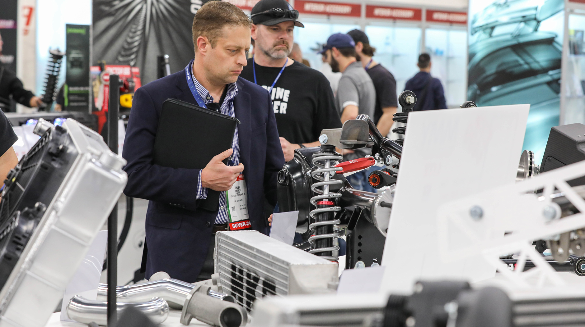 SEMA Show attendee looking at new products for 2025 SEMA Show registration