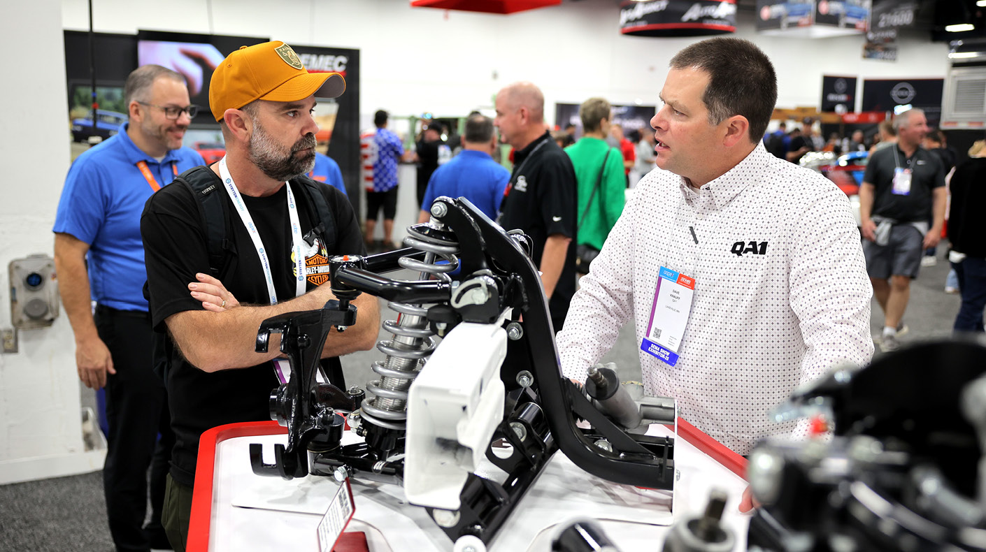 SEMA Show exhibitor having a B2B conversation in a booth.