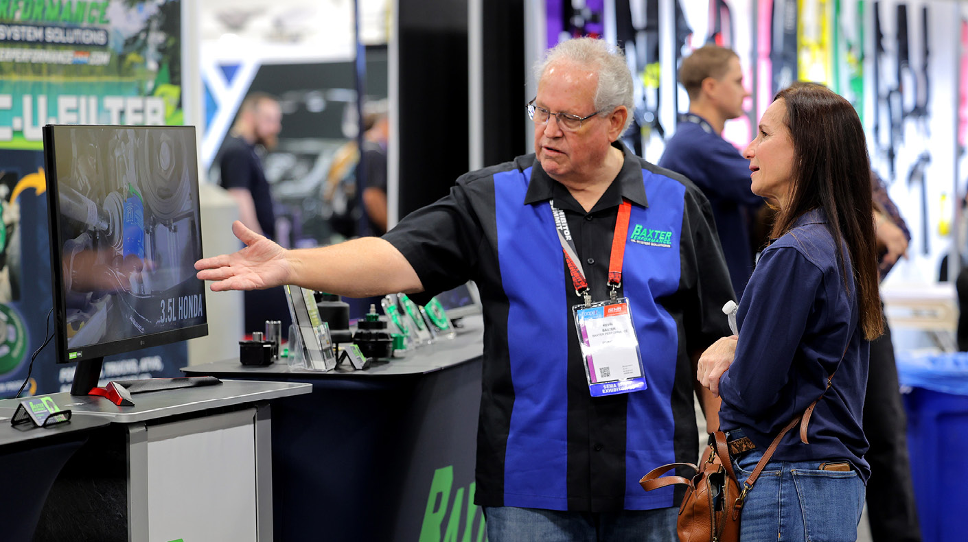 SEMA Show exhibitor talking to customer.