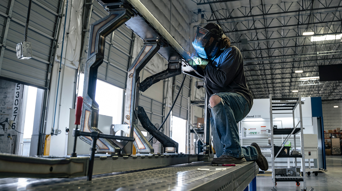 Fat Fender Garage welder working on a chassis.