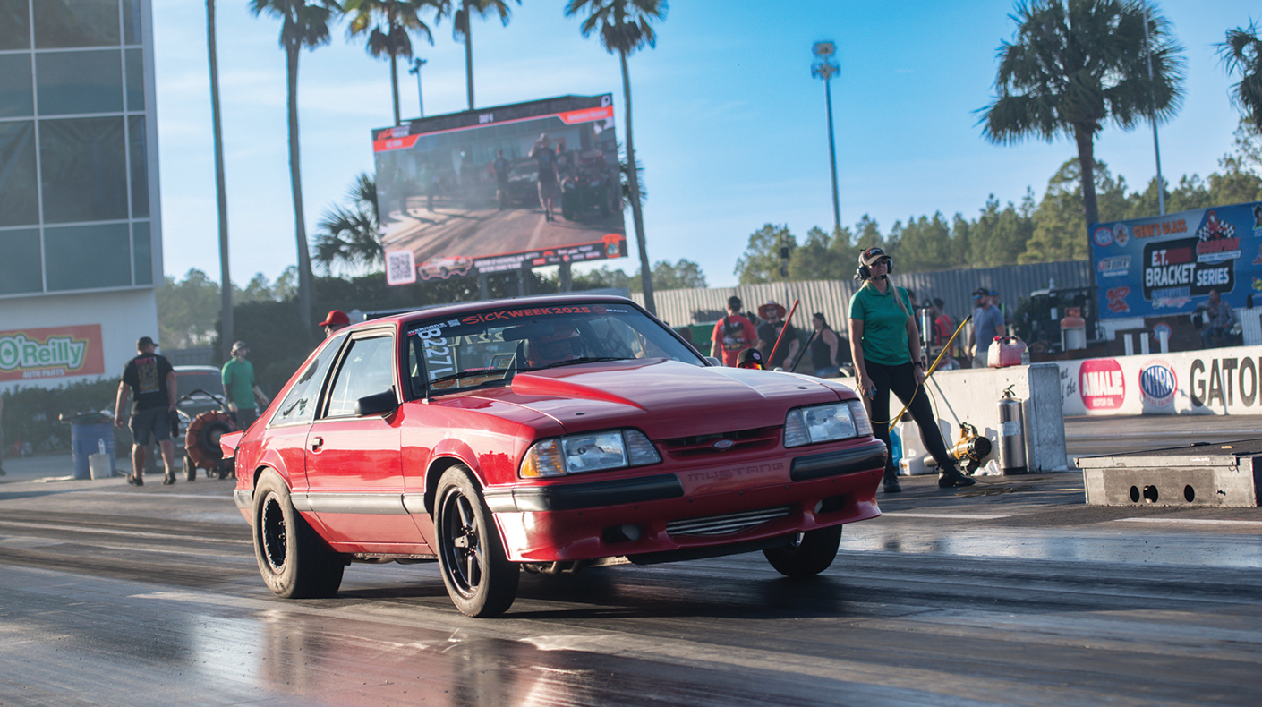 A Fox Body Mustang racing on a drag strip.