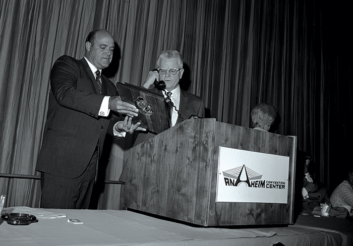 Two men at a podium at the 1969 SEMA Show