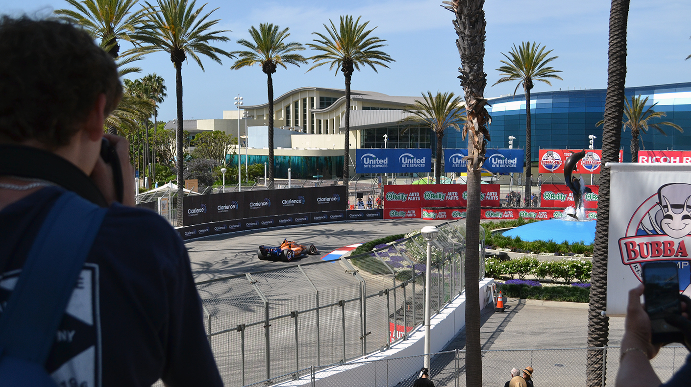 A fan taking photos at the Acura Grand Prix of Long Beach.