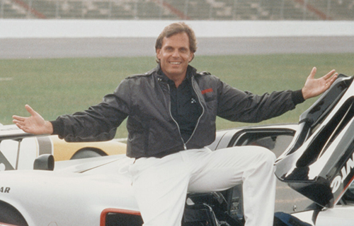 Rick Hendrick sitting on a racecar