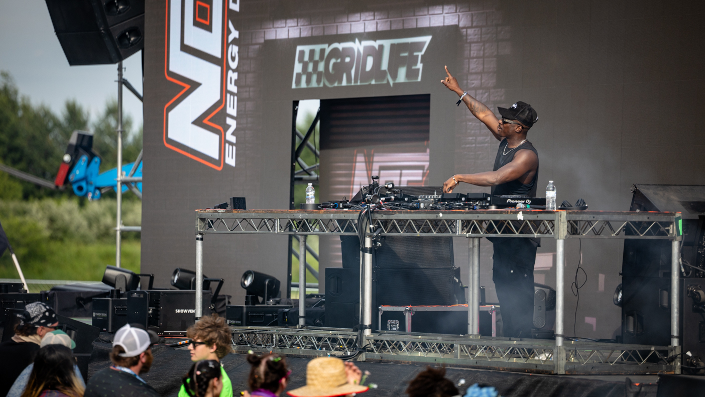 A DJ on stage at a GRIDLIFE event.