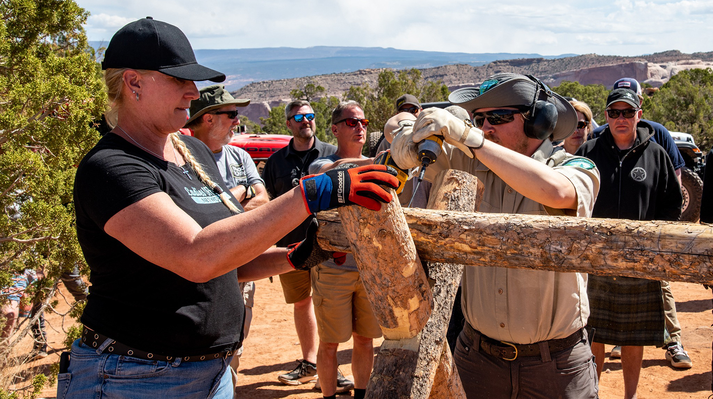 Volunteers working on a fence along an off-road trail in Moab during Easter Jeep Safari.