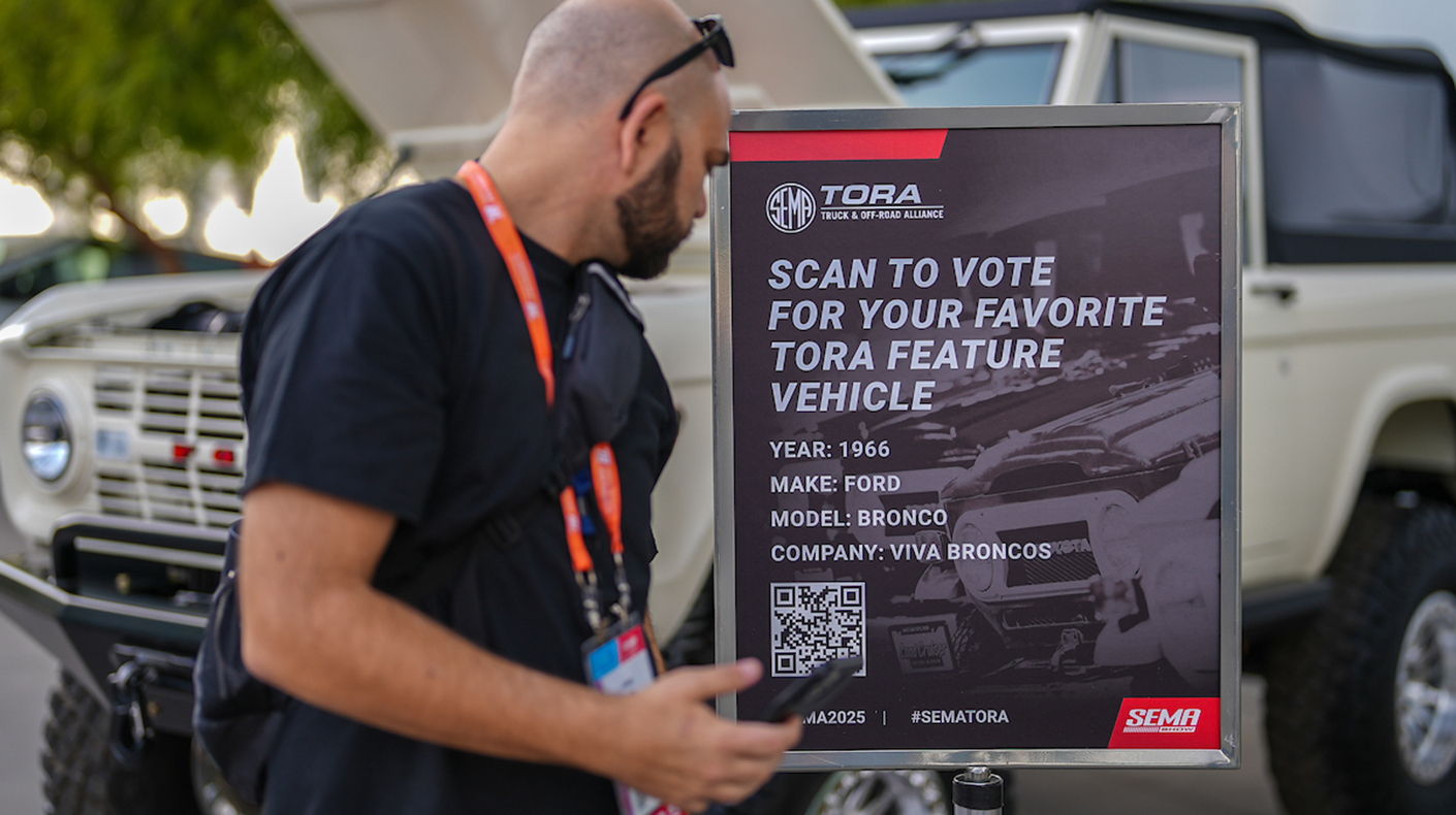 People looking at TORA Feature Vehicles.