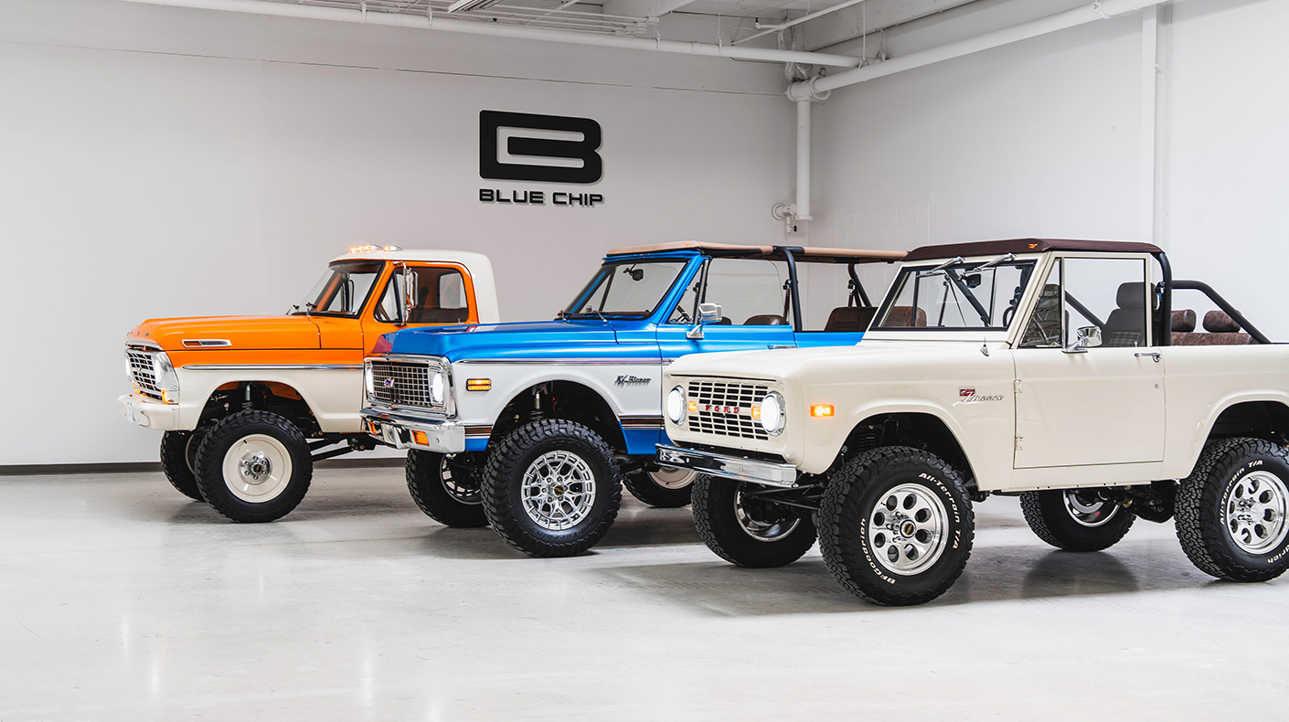 Velocity-built restomod vehicles in a dealership showroom.