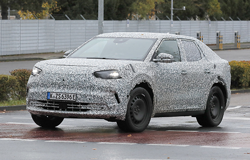 The Ford EV Crossover driving in camouflage in Europe. 