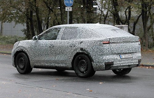 The Ford EV Crossover driving in camouflage in Europe. 