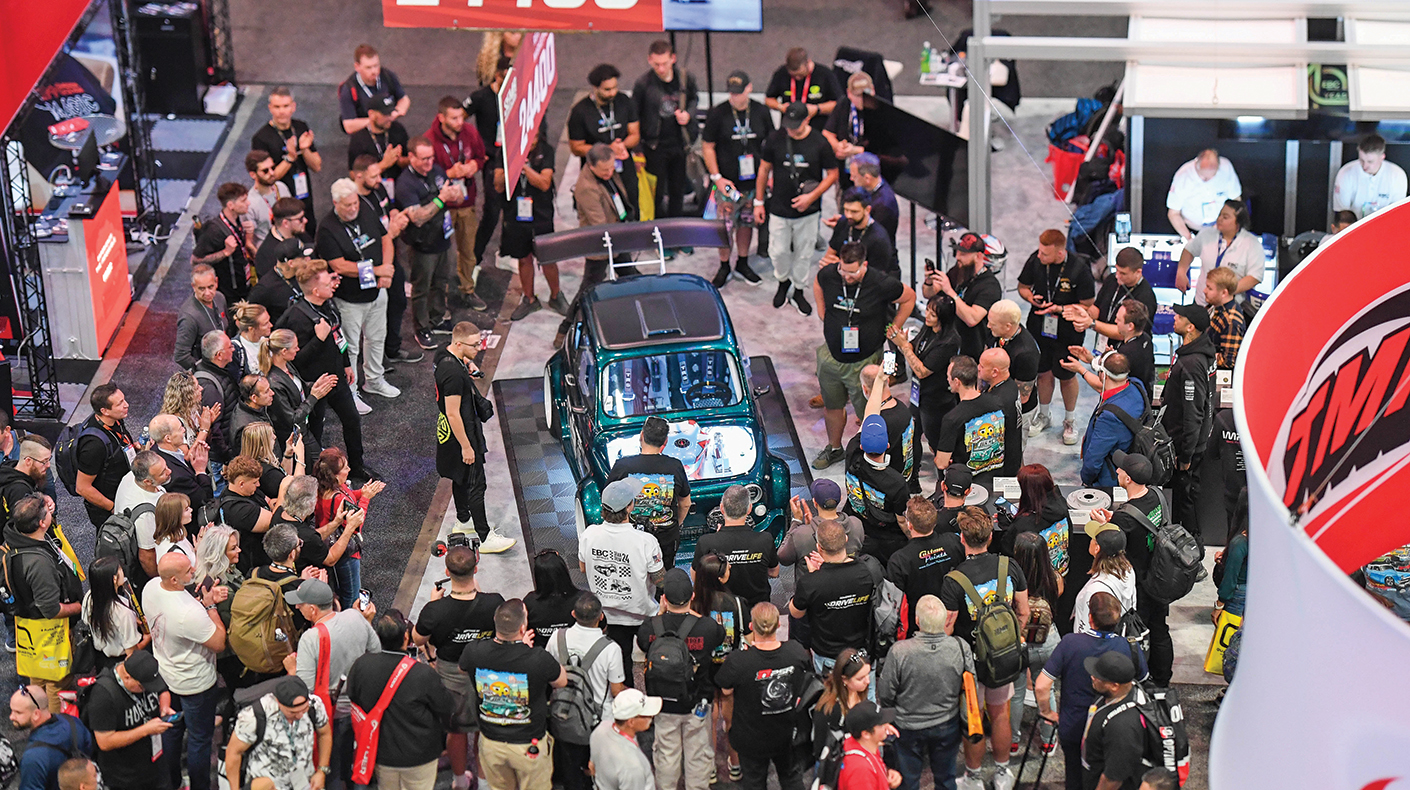 An overhead shot of a crowd gathering around a vehicle reveal at the SEMA Show.